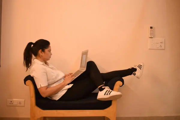 Fiatal nő laptopon tanul otthon kényelmes pózban – a Vig-Village kényelmes tanulási lehetősége