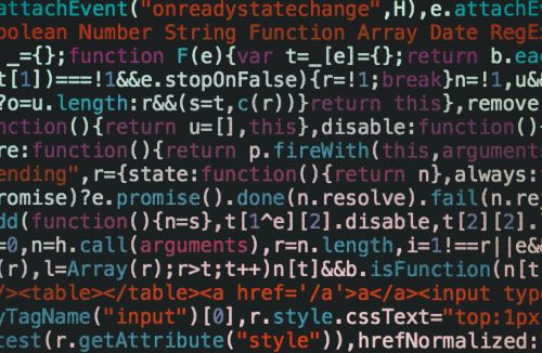 Colorful lines of JavaScript code on a black background, representing the technical foundation of artificial intelligence.