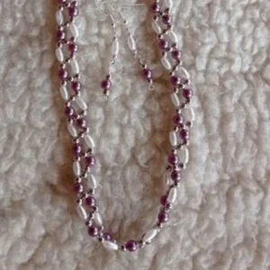 Purple and white necklace and earring set with cross-threaded bead design.
