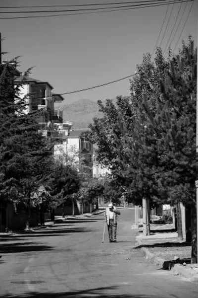 An elderly person walking on the street, illustrating daily exercise.