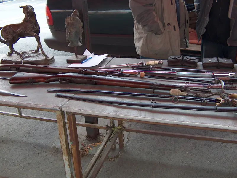 Old swords and weapons lined up on a table at the Flower Market Fair in Budaörs, October 2005.