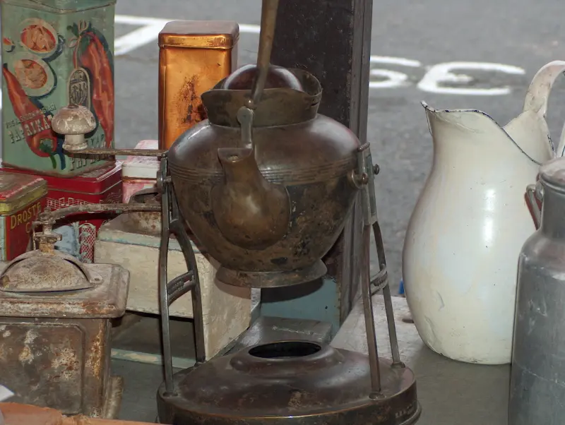 Old teapot, coffee grinders and kitchen utensils on a table at the Flower Market Fair in Budaörs, October 2005