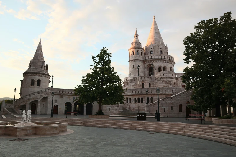 A fountain in the foreground. The three pointed towers of the Fisherman's Bastion in the background.