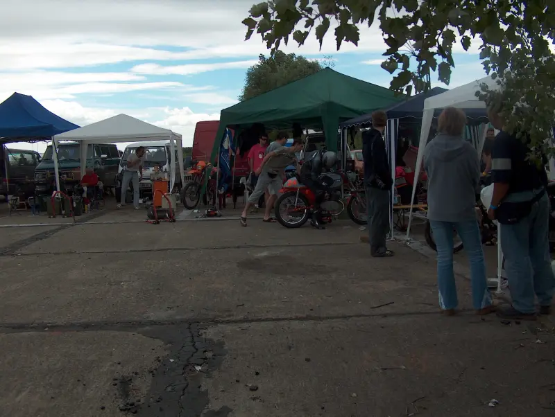 The variously colored and sized fairground tents at the motor racing venue are visible.