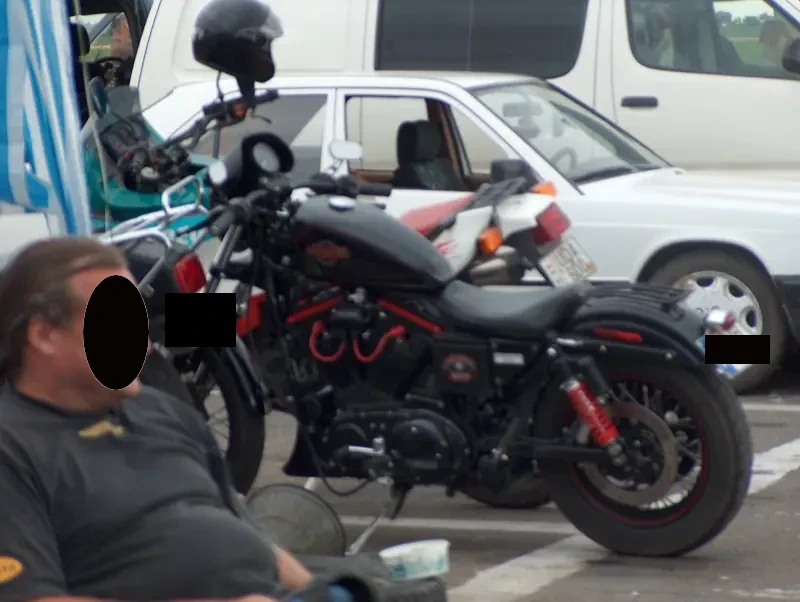 A black motorcycle. Cars around it