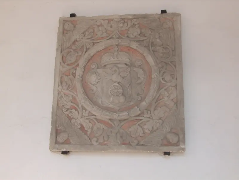 Decorative carved stone coat of arms with crown motif at Sárospatak Castle.”