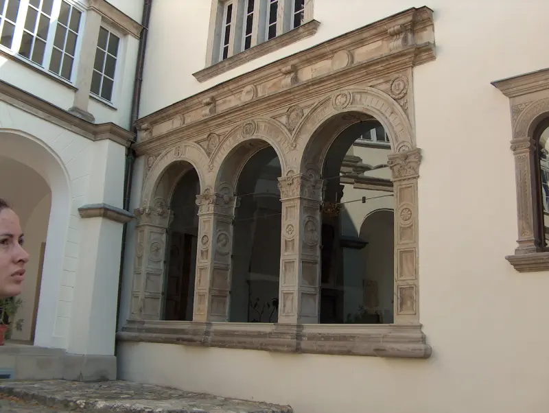 Three-arched Renaissance window with carved stone frames at the loggia of Rákóczi Castle.”
