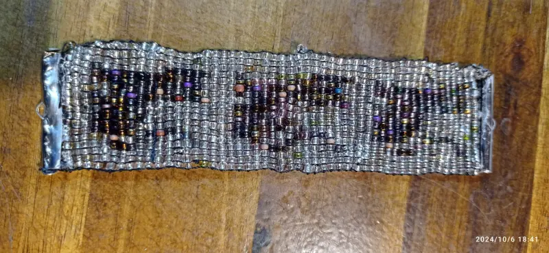 A string of kittens made using bead weaving technique