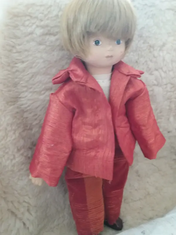 Boy doll in red sewed suit