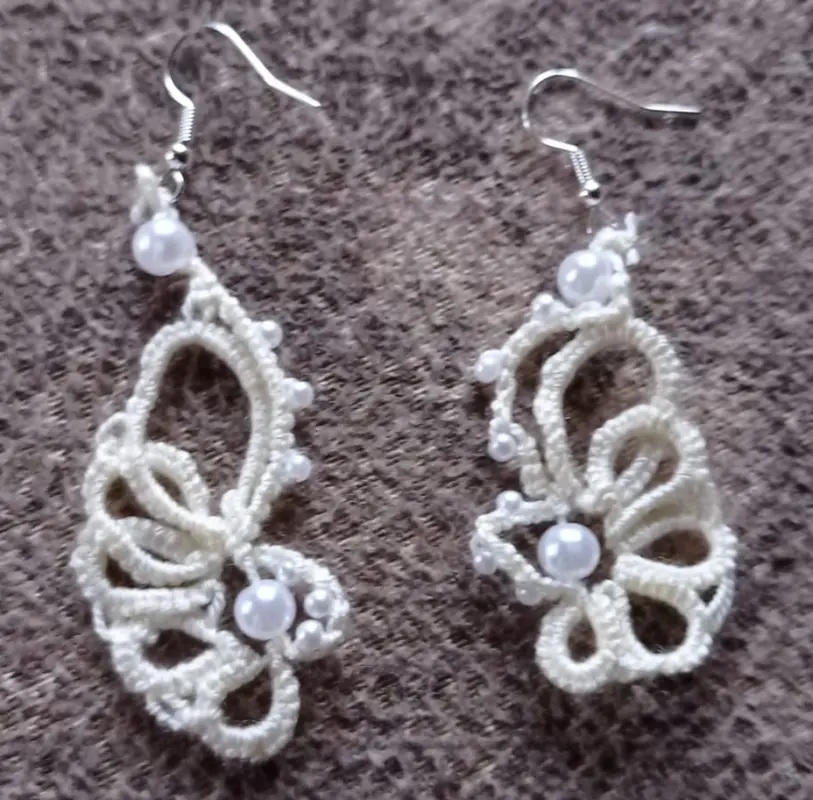 White earrings with beads made using tatting technique